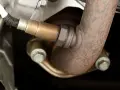 Sonda lambda spia, parte di un sistema di scarico arrugginito.