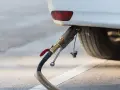 Rifornimento di un'auto a gas. Il tubo di erogazione è collegato all'attacco, pronto per il pieno. GPL e metano sono la stessa cosa per molti, ma non è così.