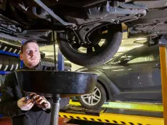 Meccanico osserva l'olio esausto del cambio, chiedendosi ogni quanti km si cambia l'olio del cambio per mantenere l'auto in salute.