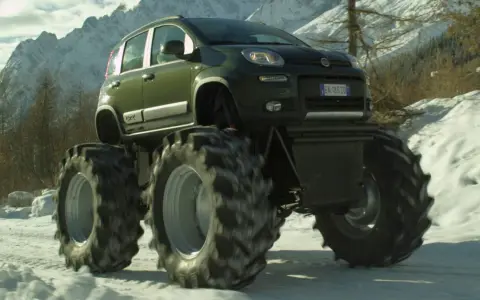 Un'auto verde con enormi gomme da trattore su un terreno innevato. Sembra che si possa montare gomme da 17 su cerchi da 16 per un look così estremo.