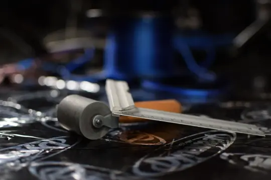 Rullo e righello pronti per l'insonorizzazione auto. Materiale isolante nero con grafiche.
